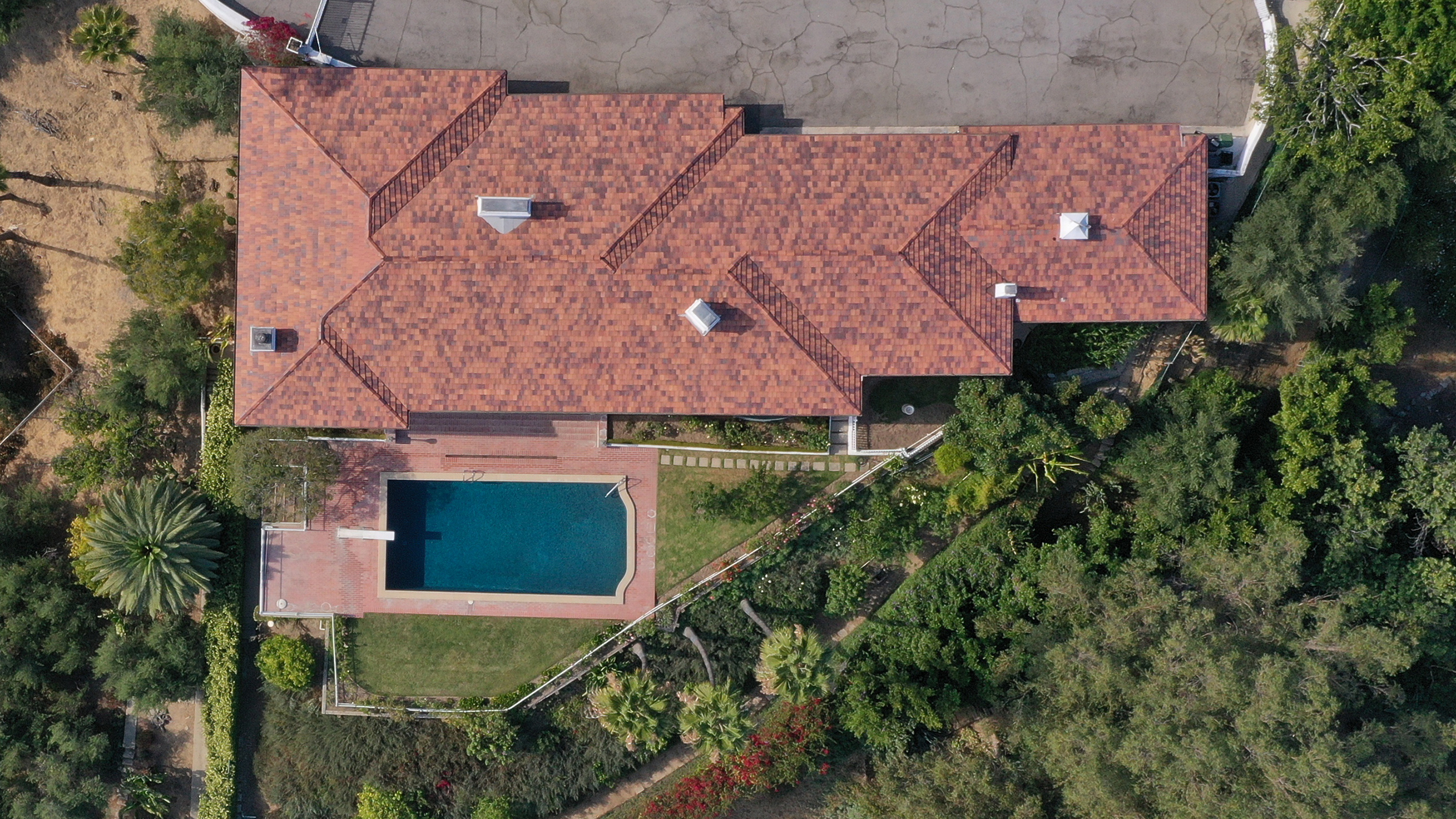 Drone capturing aerial view of residential real estate listing