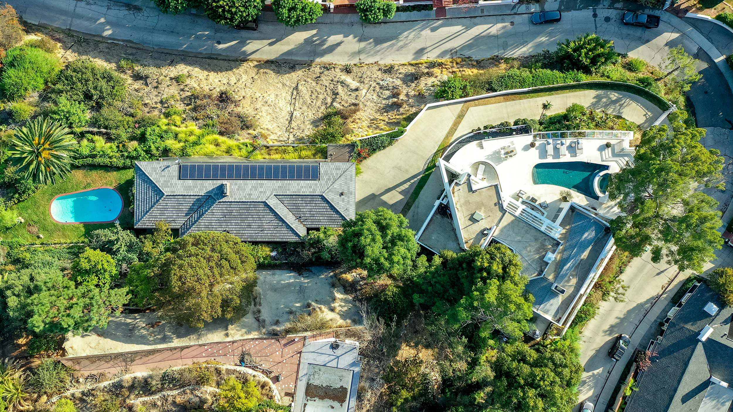 drone shot of a residential property showing the whole site with house yard and pool